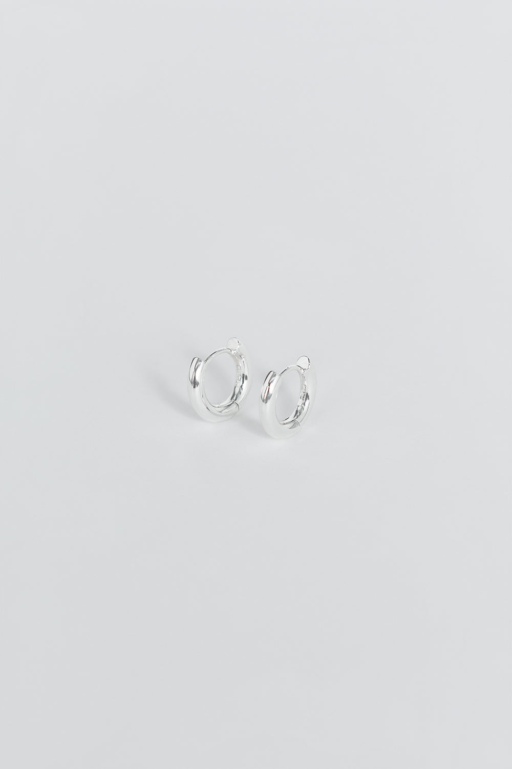 LUV AJ Amalfi Silver Huggie Hoop Earrings